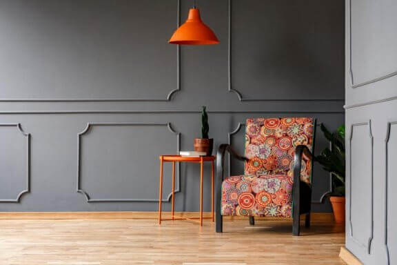 Gri ahşappiyer fon önünde parlak renkli koltuk ve avize kullanabilirsiniz.