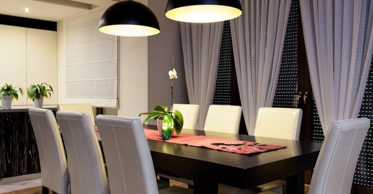 Siyah masa etrafına dizili beyaz sandalyeler